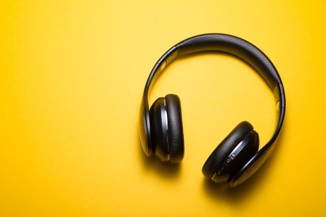 close-up of premium headphone ear cup with hand-stitched olive leather and brushed aluminium detail