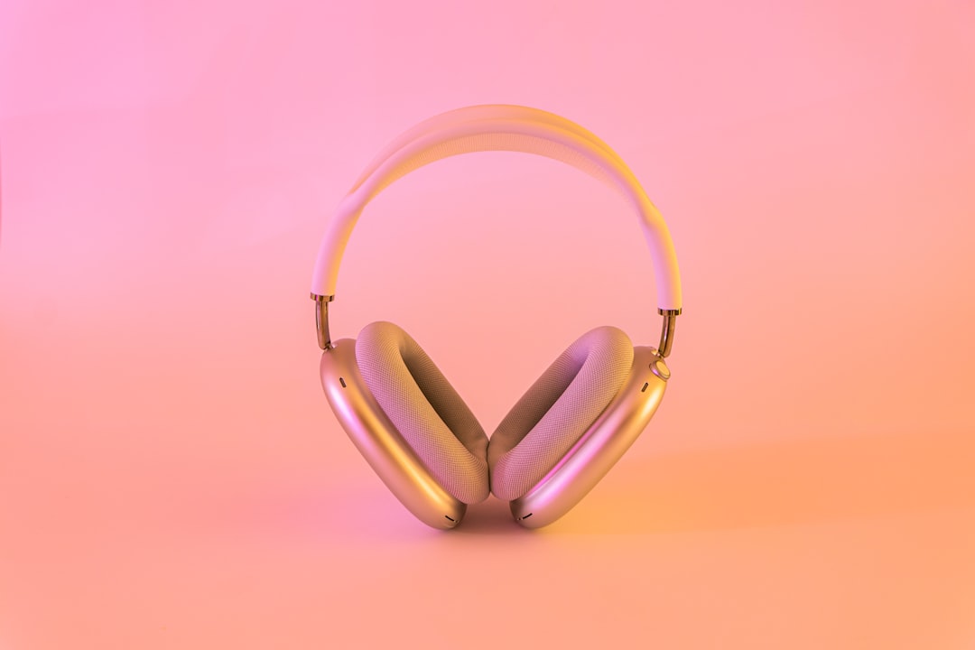 Aurora Arc earbuds in their charging case on a warm textured surface