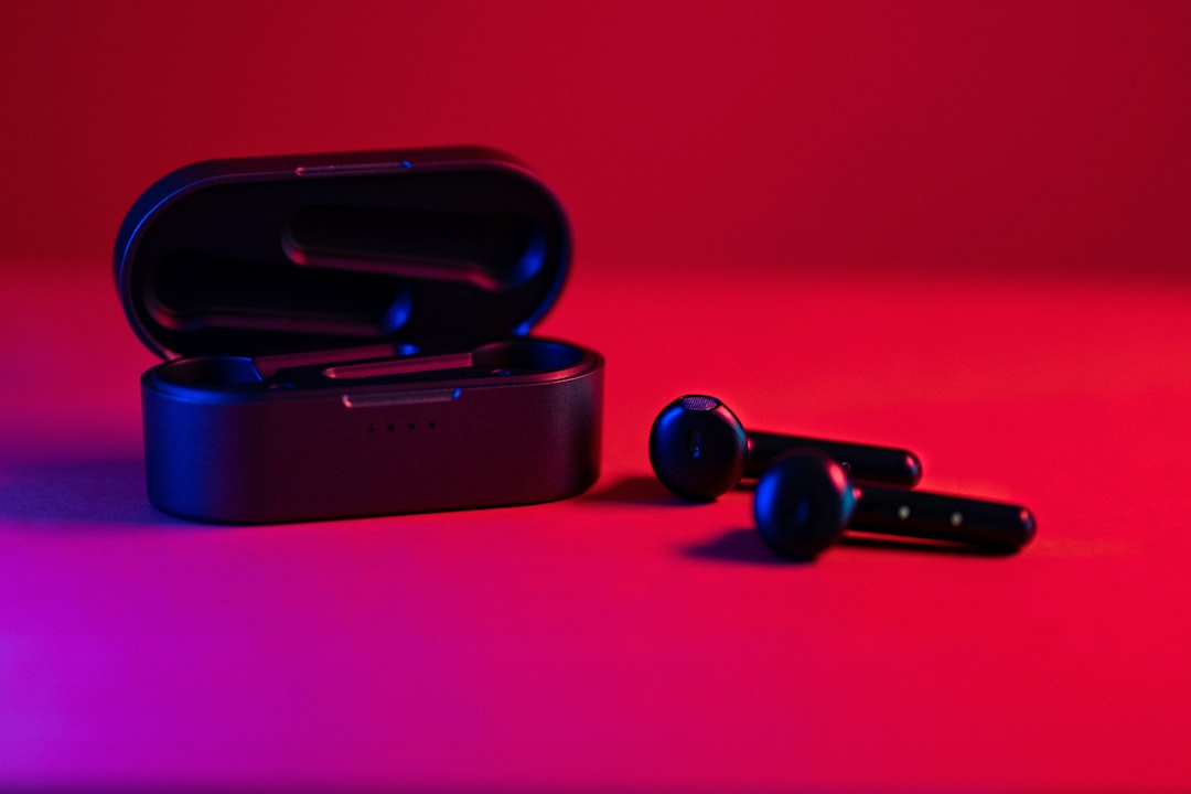 Aurora Apex Pro headphones folded and placed in a minimal olive-toned carry case