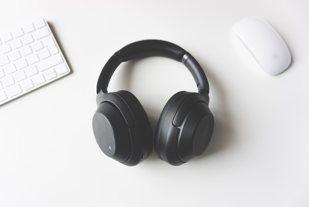 premium over-ear headphones resting on a warm linen surface in soft natural light