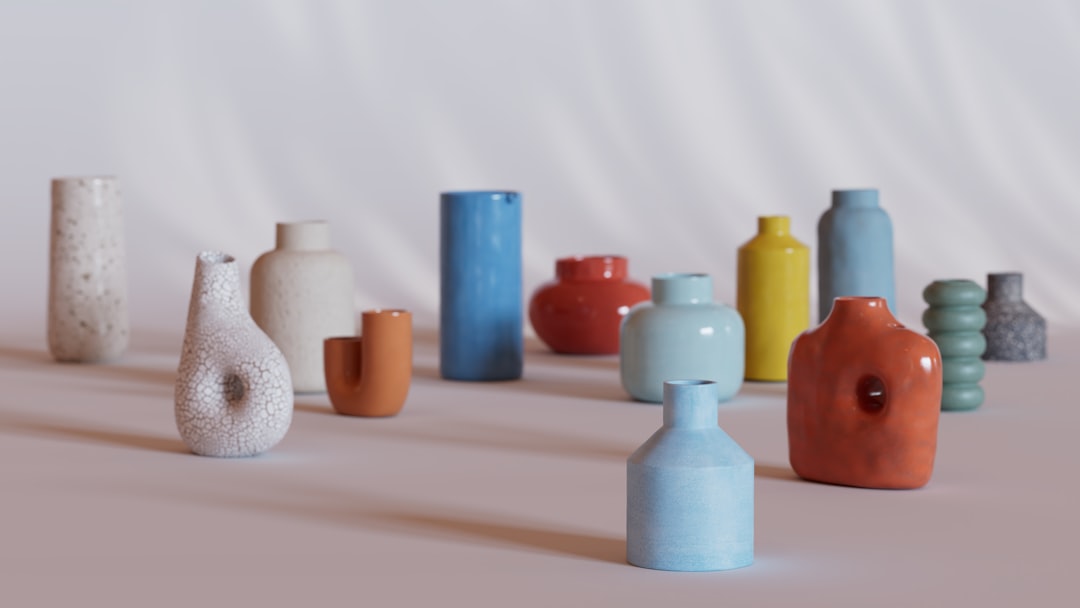 close-up of sage-glazed stoneware vase with textured surface catching side light