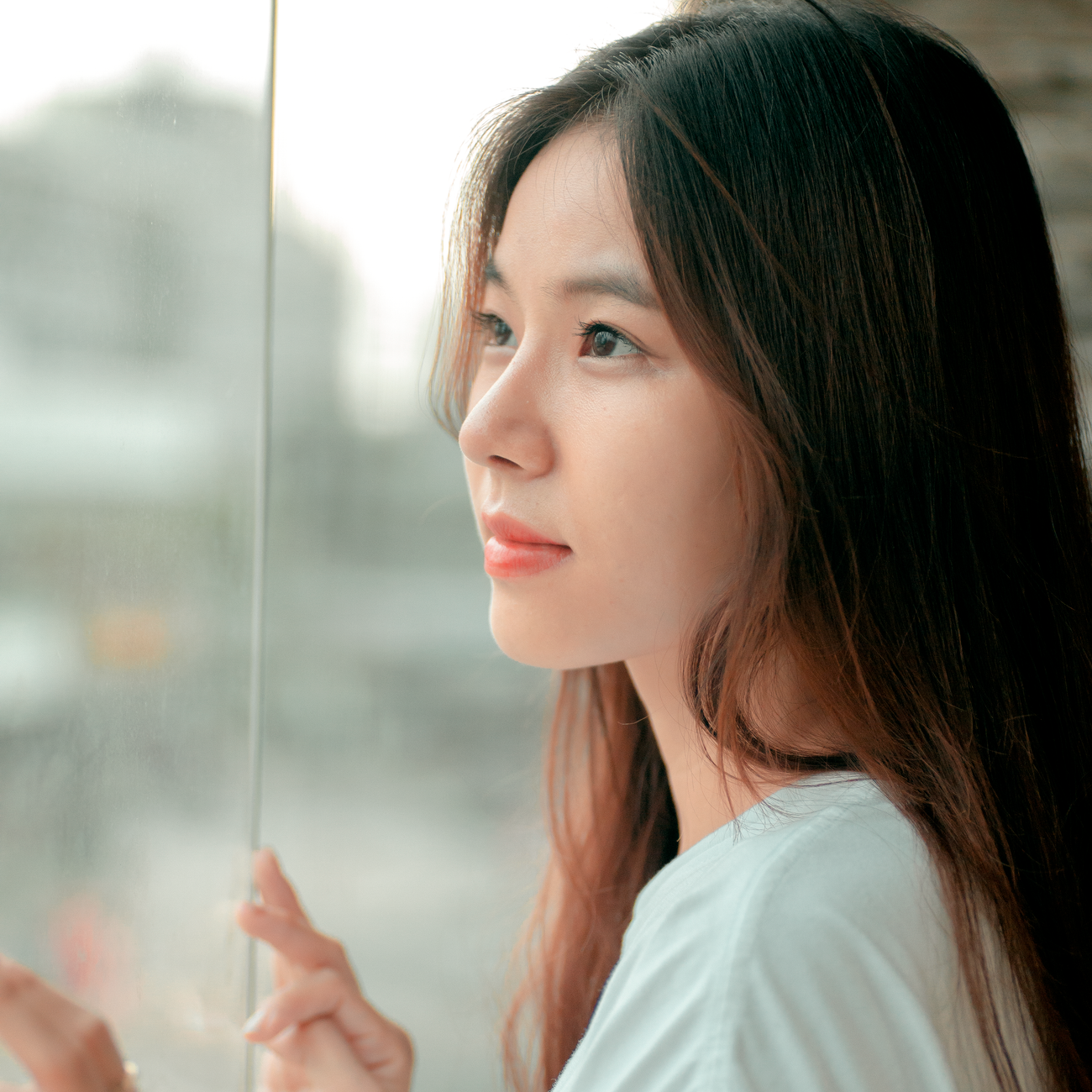 portrait of startup founder in front of large window with city skyline in the background