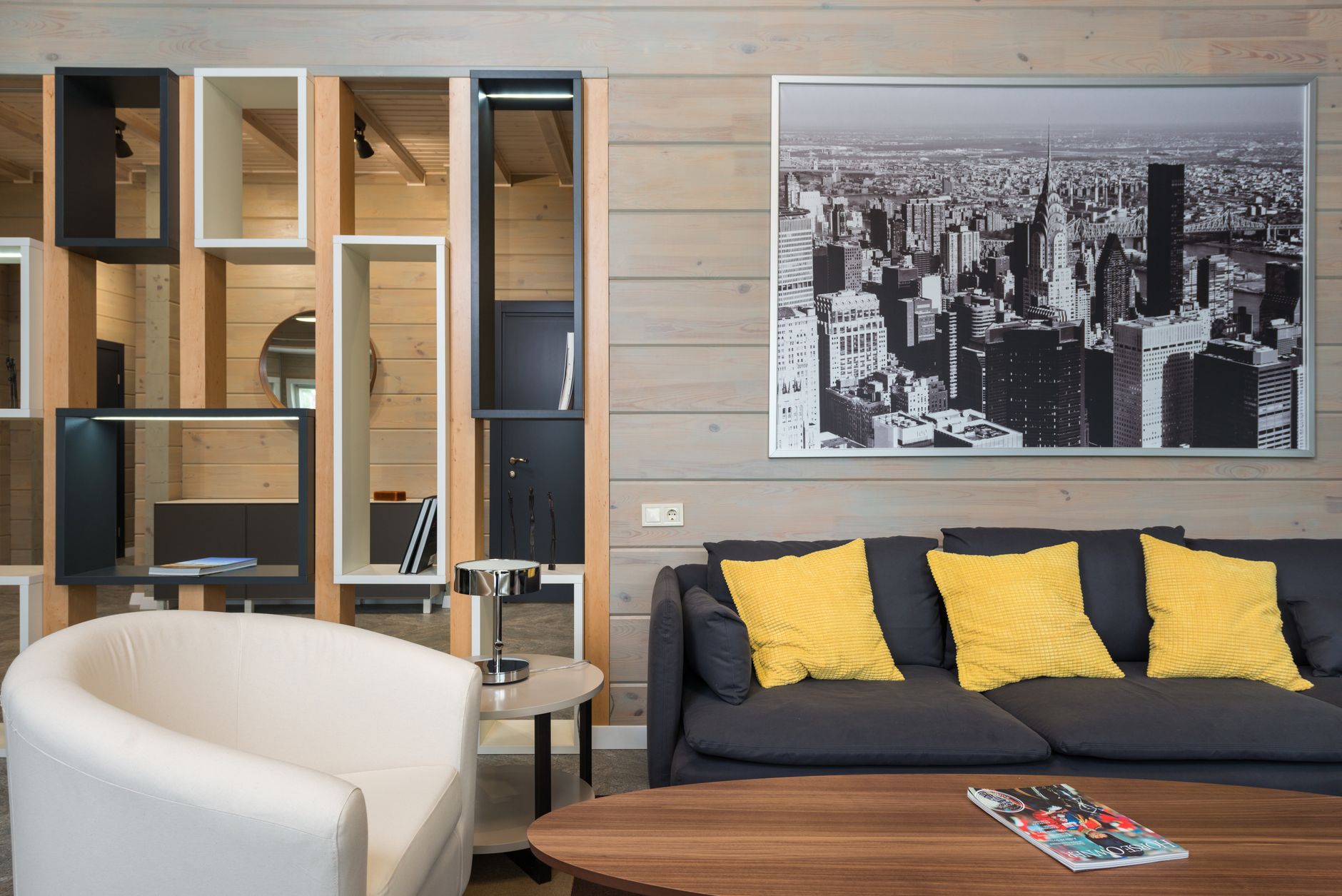 bright modern studio common area with large windows and colorful typography prints arranged on white walls