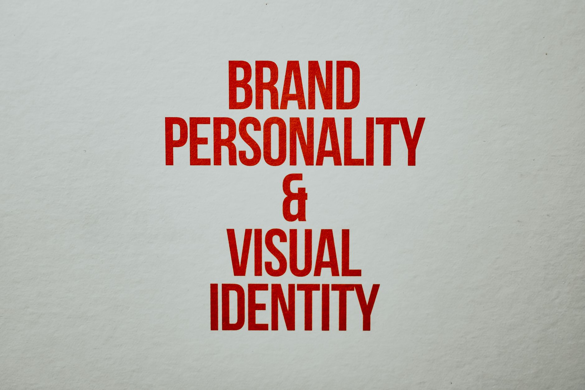playful gradient brand identity poster with bold typography on studio wall in creative office