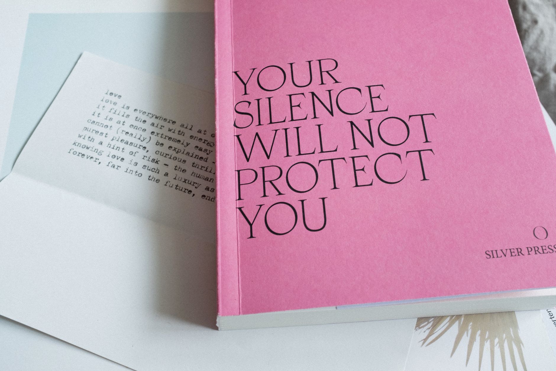 editorial packaging design for small press book with textured paper and vivid spot color print