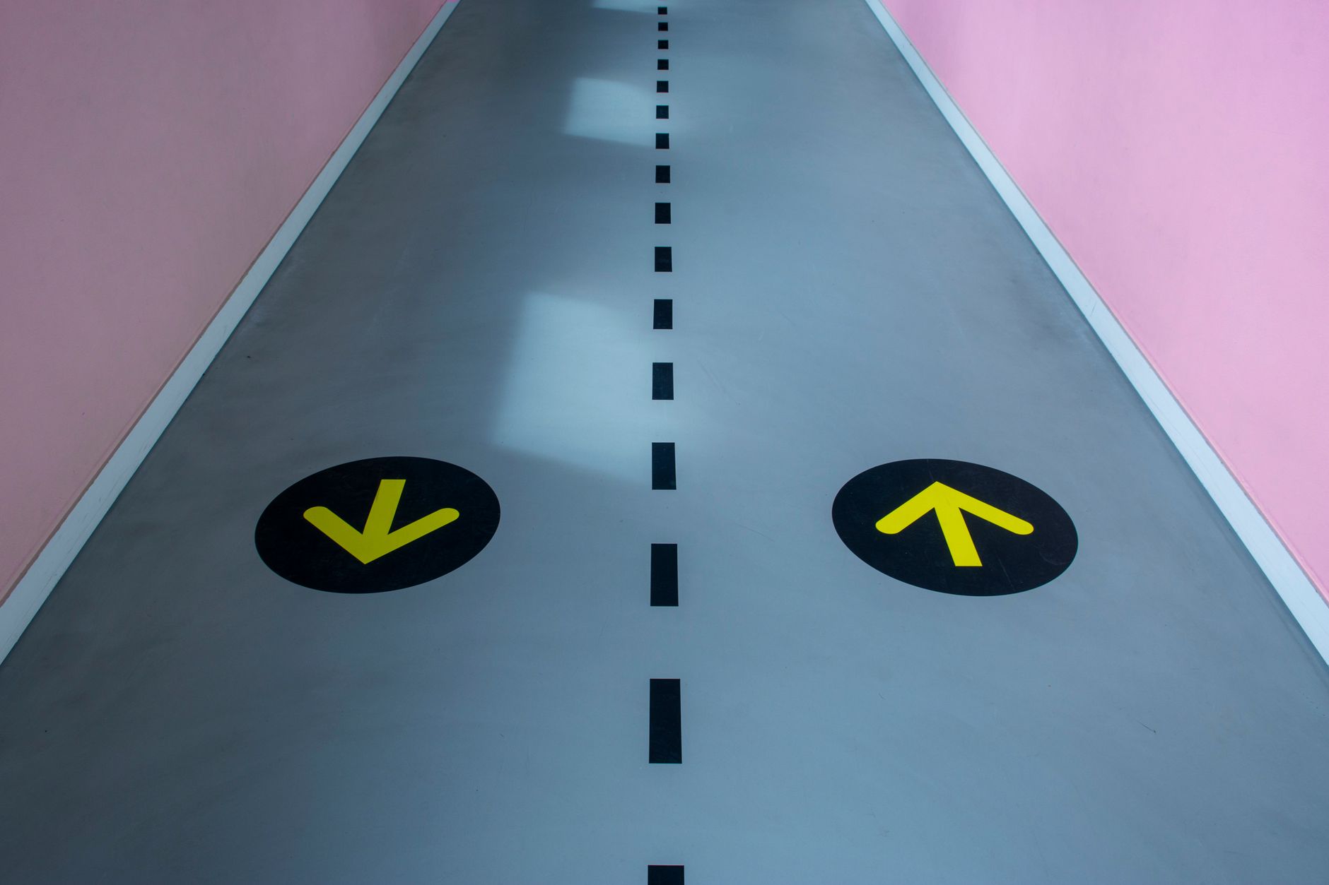 bright coworking hub wayfinding design with color-coded zones and floor mounted graphic arrows