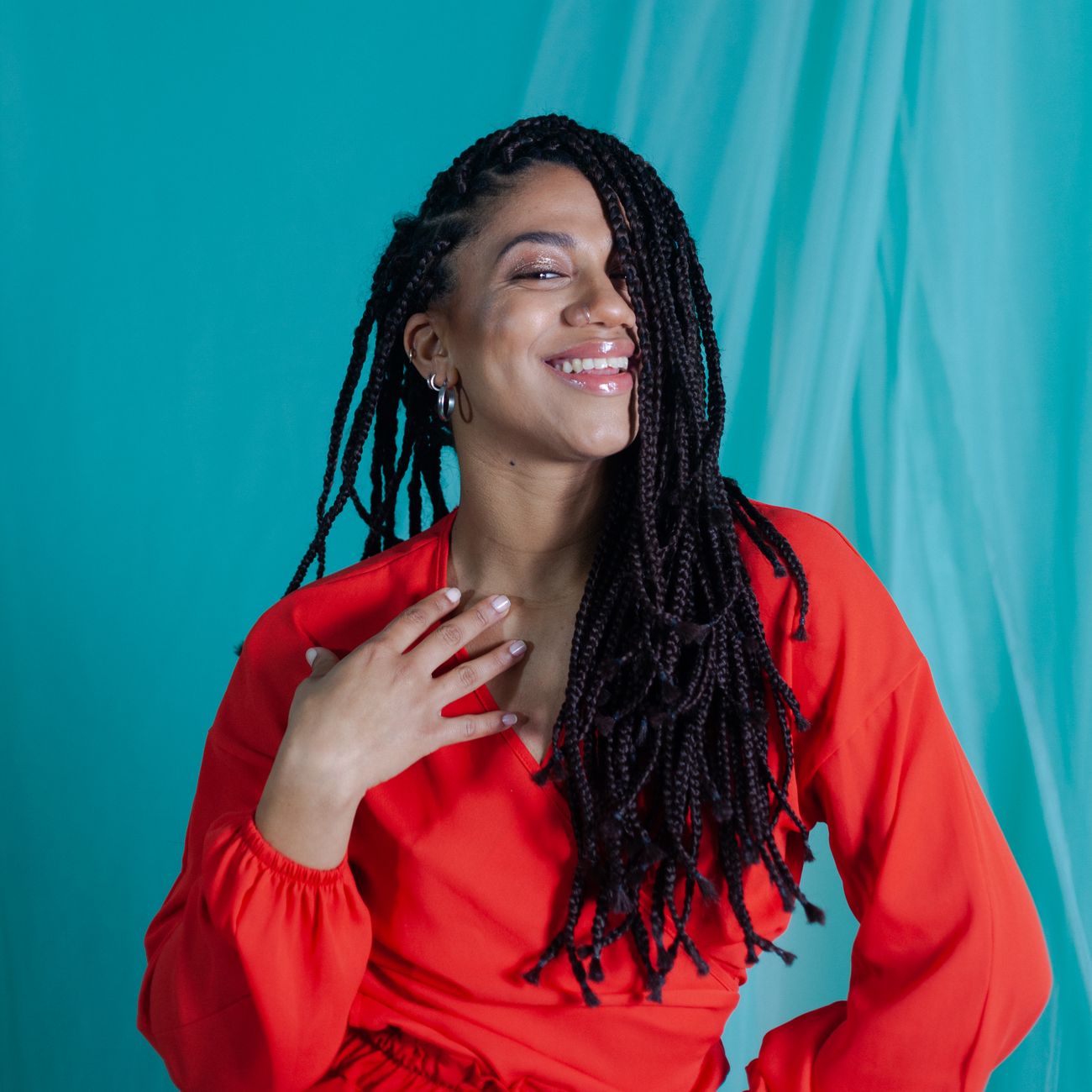 portrait of creative director with bold style smiling in vibrant design studio surrounded by colorful mood boards