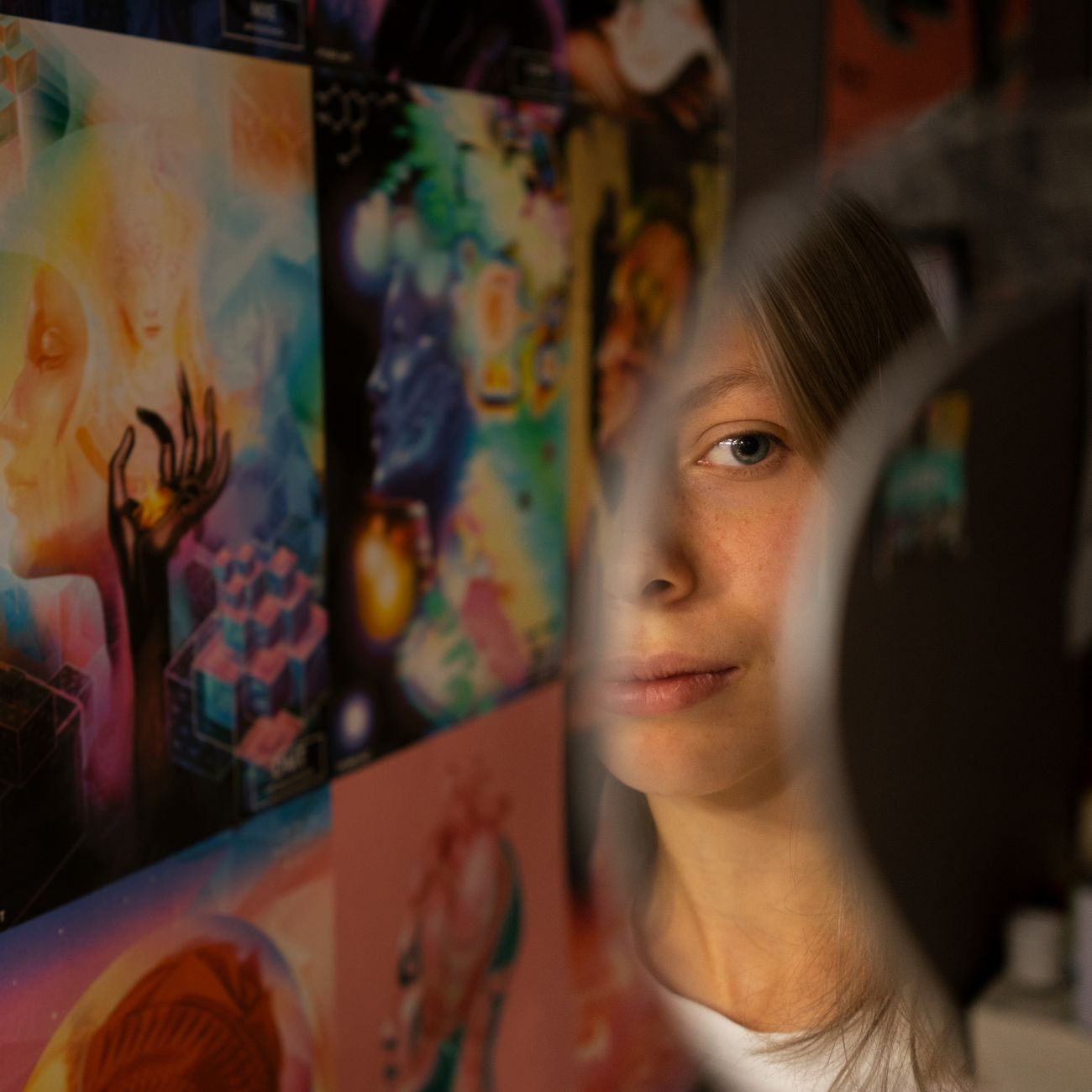 portrait of motion designer with expressive energy in front of multiple monitors showing colorful animation work
