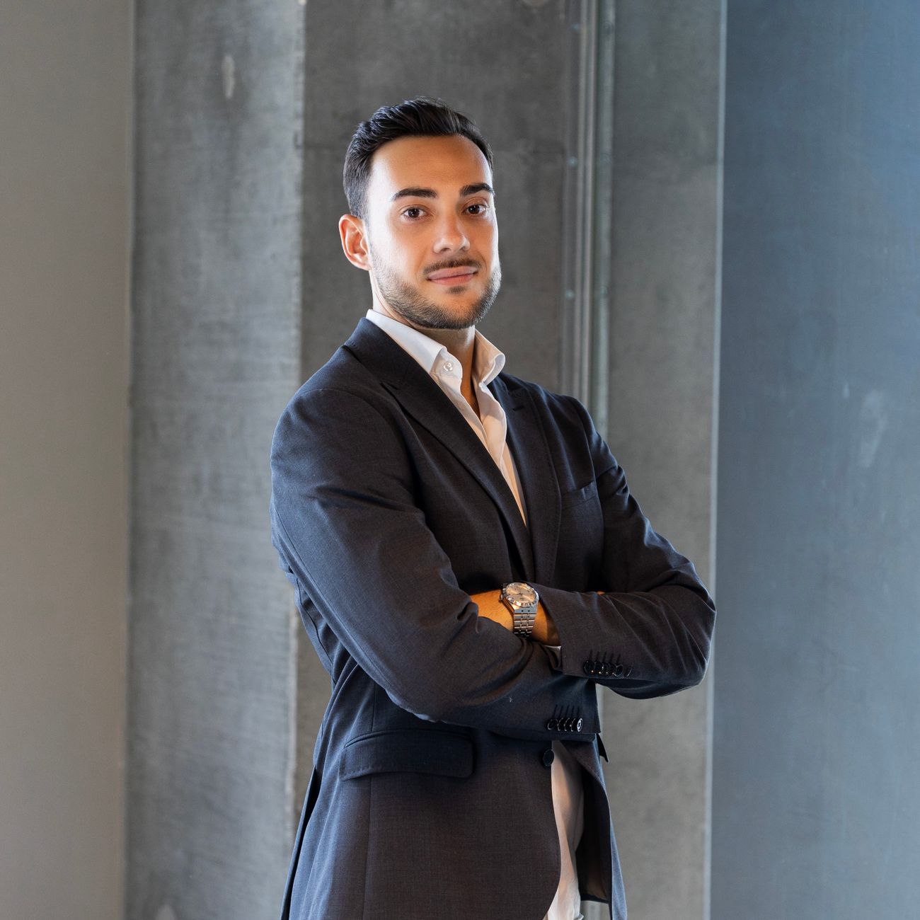 professional headshot of male real estate agent in light filled modern office with calm confident expression