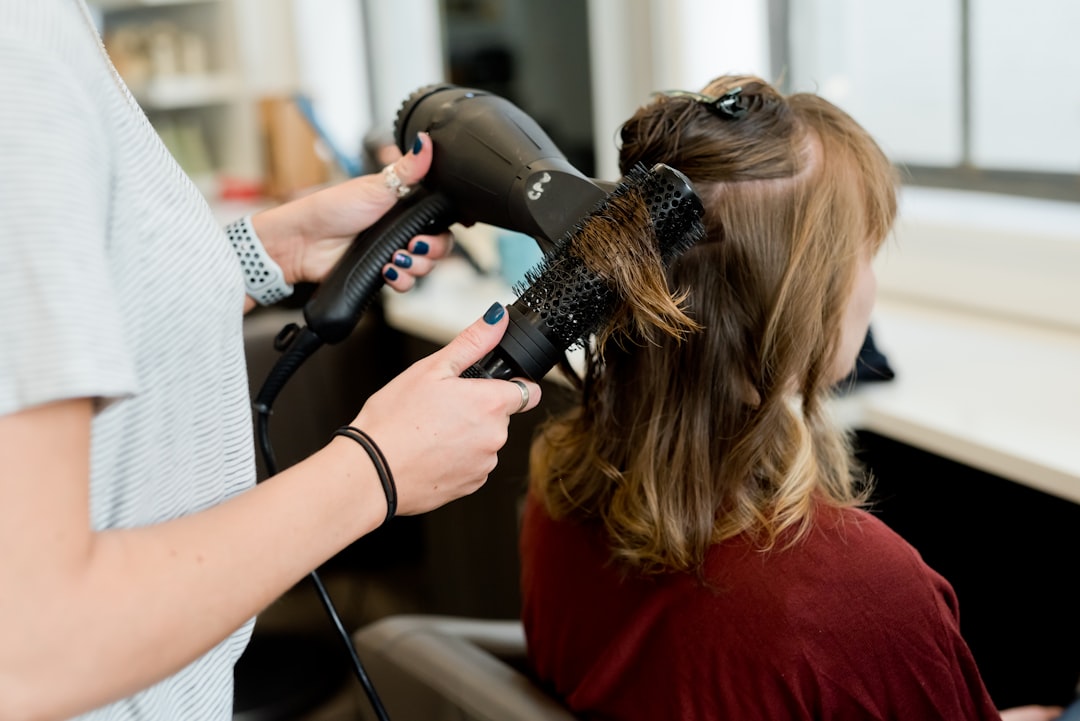 stylist applying balayage colour technique on client hair